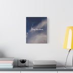 Wall art with 'Stay the course.' text on a shelf with books and a lamp.