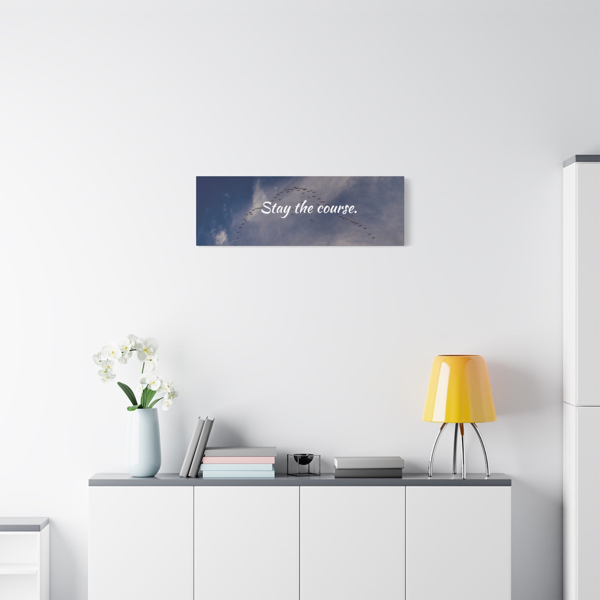 Wall art with motivational quote 'Stay the course.' in a modern interior setting.