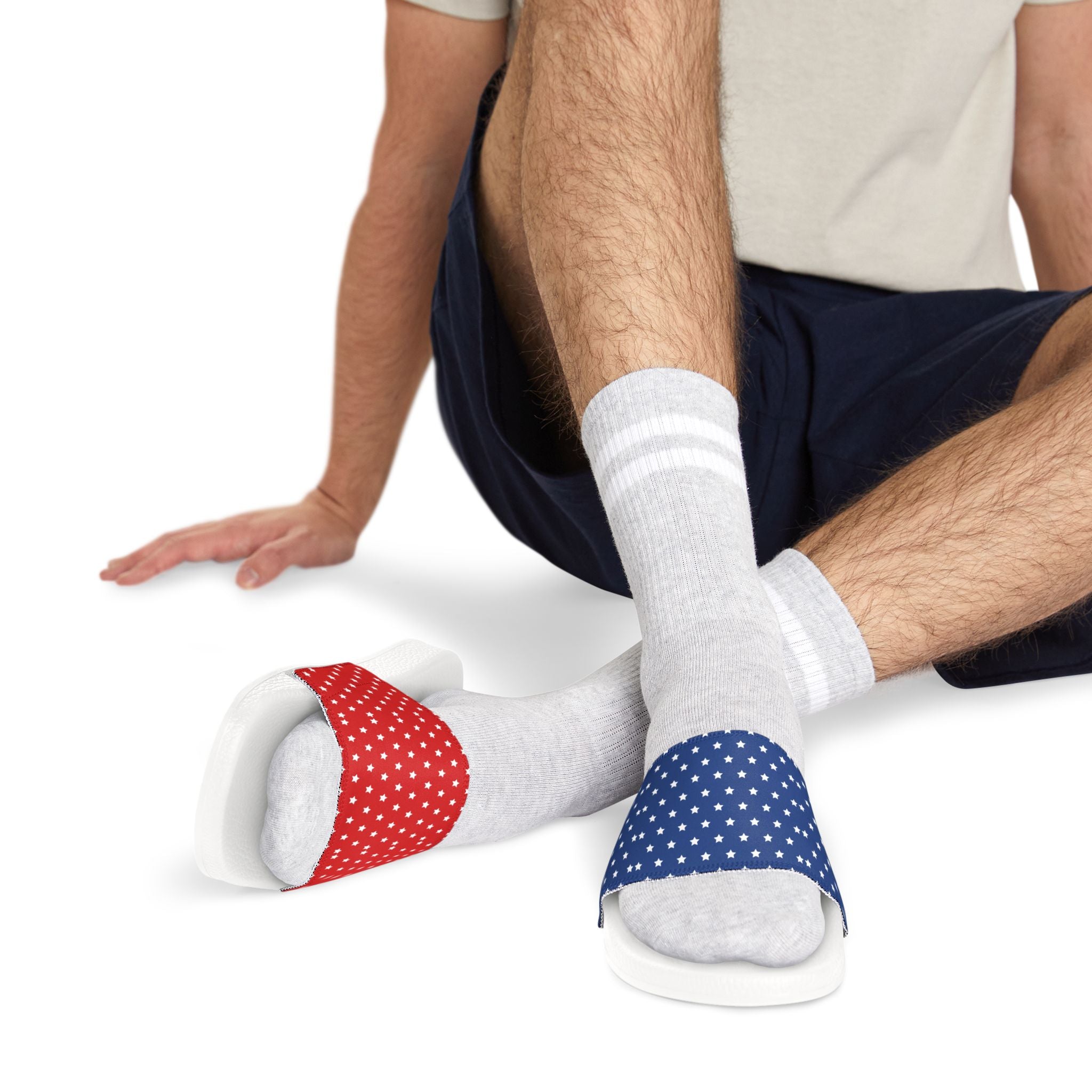 Person wearing white socks with red and blue polka dot ends on a white background