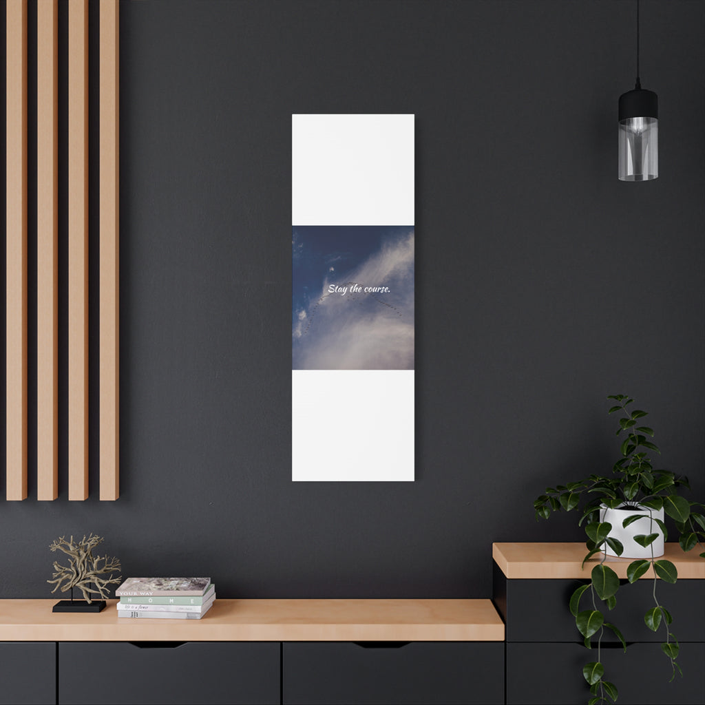 Vertical wall art with a blue sky and white cloud design on a dark wall.
