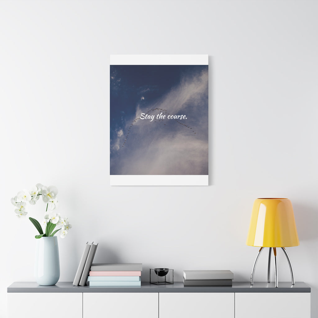 Framed artwork with motivational quote on a wall above a shelf with decor items.