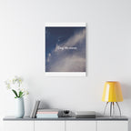 Framed artwork with motivational quote on a wall above a shelf with decor items.