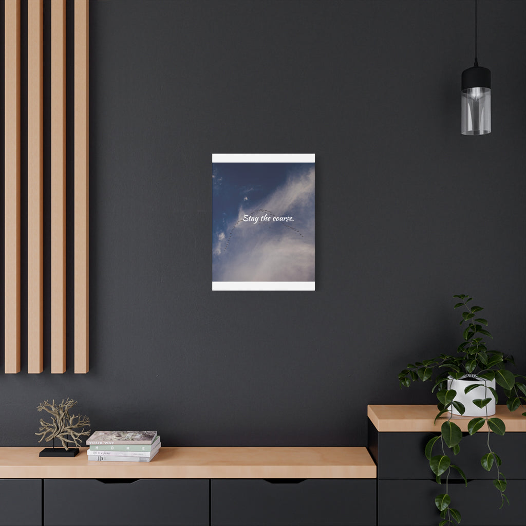 Framed artwork on a dark wall with wooden shelves and decor