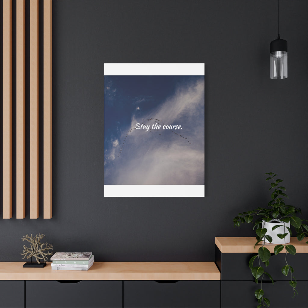Framed artwork with 'Stay the course.' text on a dark wall with decor elements.