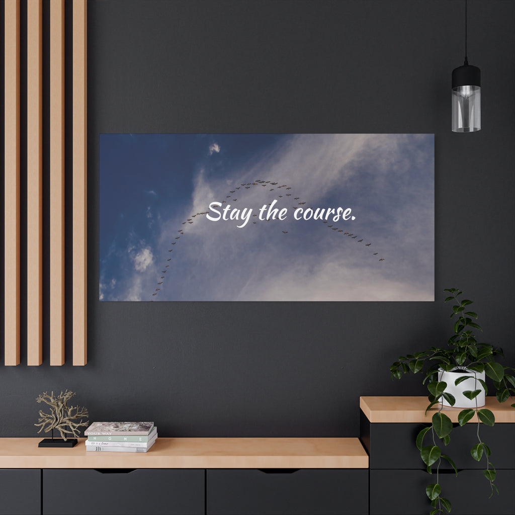 Poster with 'Stay the course.' text on a blue sky background in a modern interior setting.