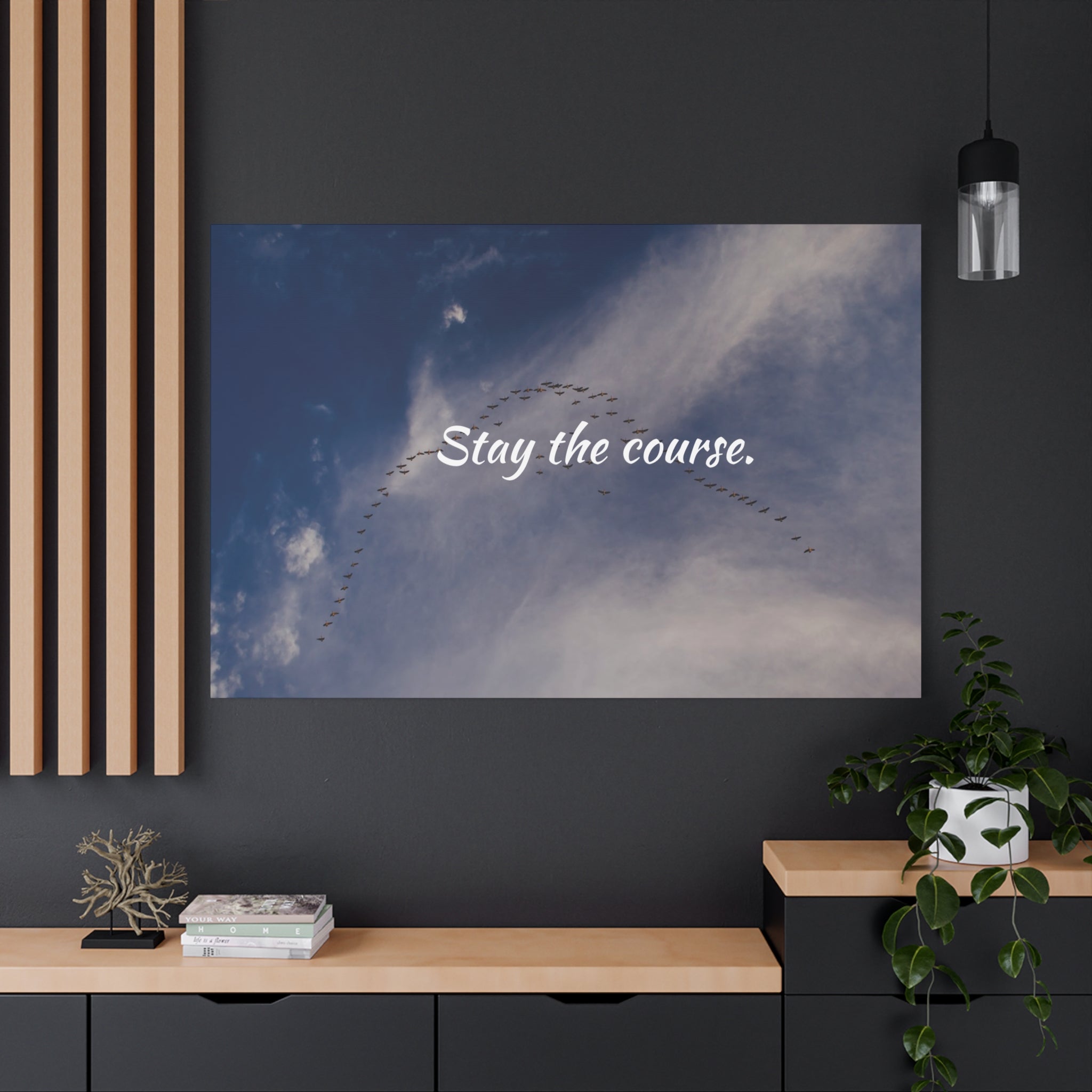 Poster with 'Stay the course.' text on a wall in a modern interior setting.
