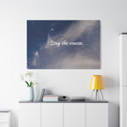 Wall art with 'Stay the course.' text above a desk with decor items.
