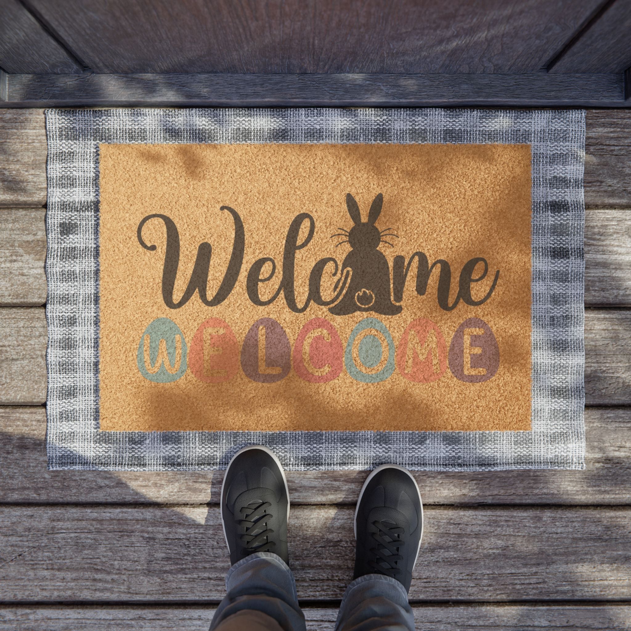 Doormat with 'Welcome' text and rabbit silhouette on wooden floor