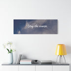 Wall art with 'Stay the course.' text above a shelf with decor items.