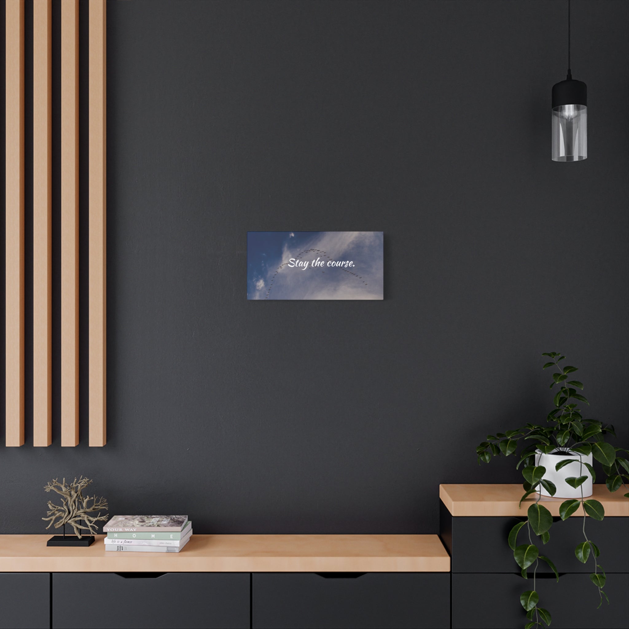 Modern interior with a dark wall, wooden shelf, and decorative items.