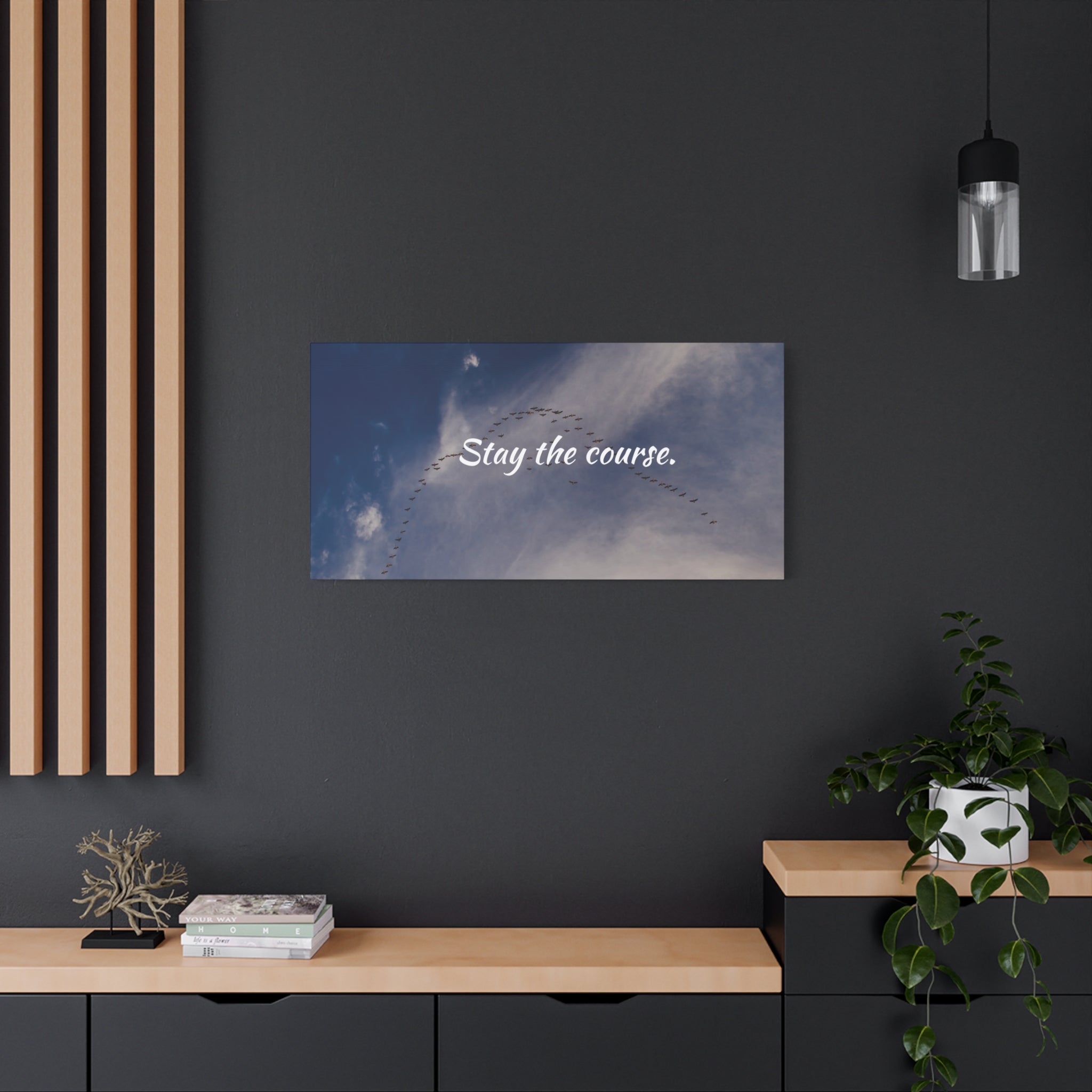 Wall art with 'Stay the course.' text in a modern interior setting.