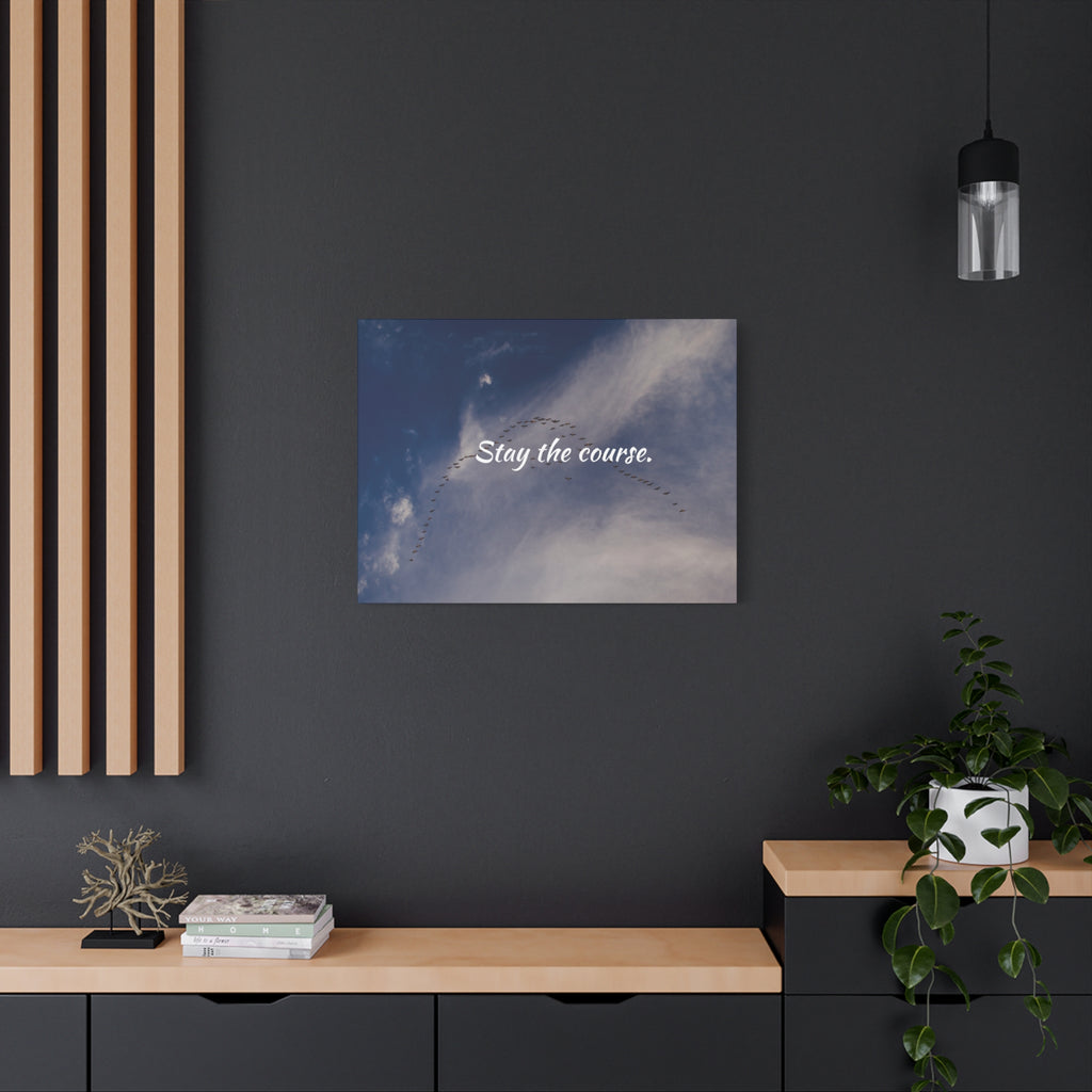 Poster with 'Stay the course.' text on a dark wall above a wooden shelf.