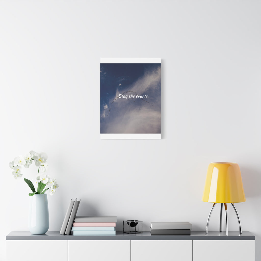 Framed artwork with motivational quote on a wall above a shelf with decor items.