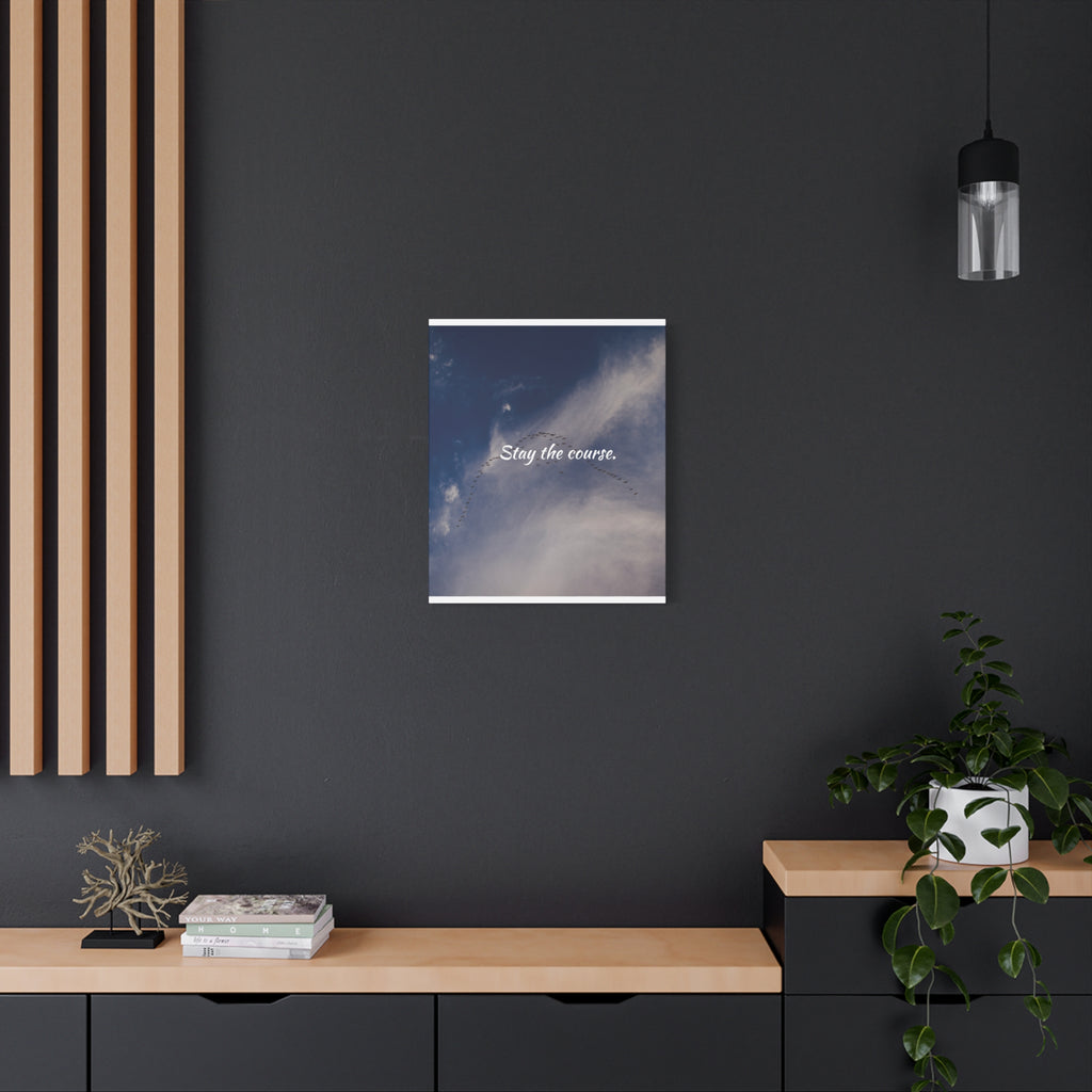 Framed artwork with a motivational quote on a dark wall in a modern interior setting.