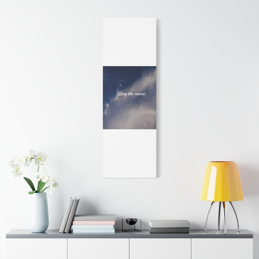 Poster with text on a wall above a shelf with decor items