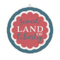 Decorative sign with 'sweet land of liberty' text on a white background