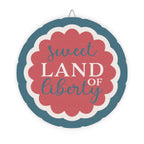 Decorative sign with 'sweet land of liberty' text on a white background