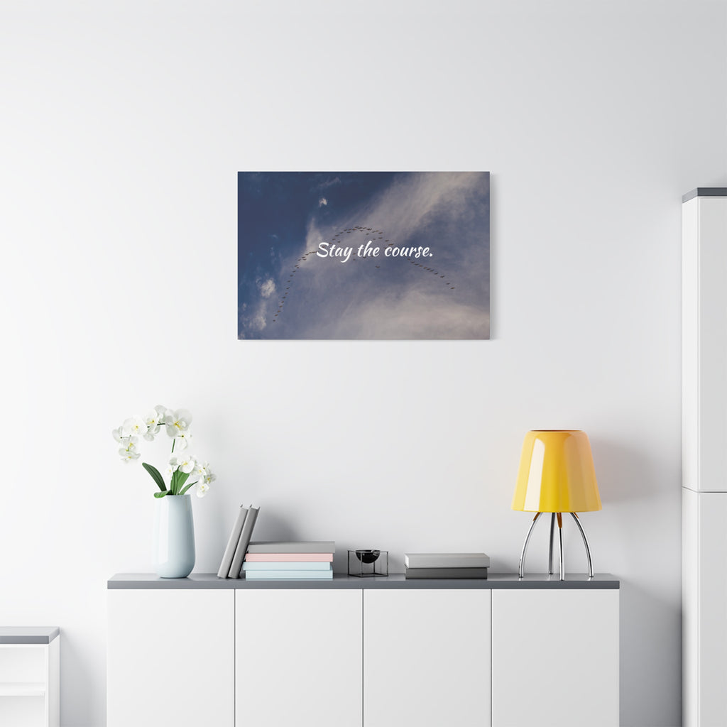 Wall art with 'Stay the course.' text in a modern interior setting.