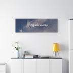 Wall art with 'Stay the course.' text above a desk with decor items.