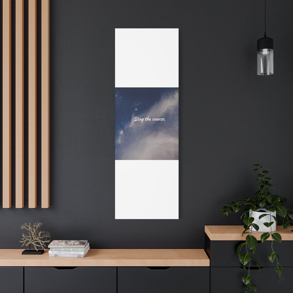 Vertical artwork on a dark wall with wooden shelf and plant