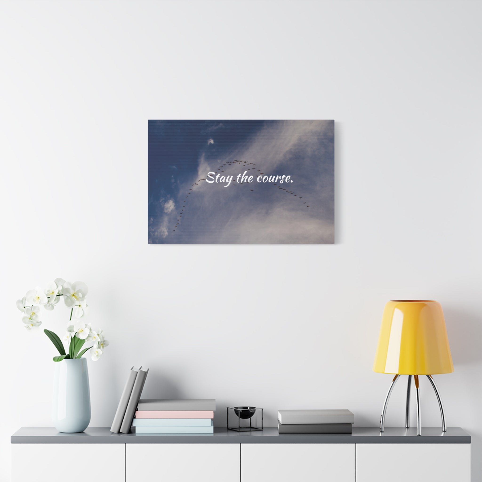 Wall art with 'Stay the course.' text in a modern interior setting.