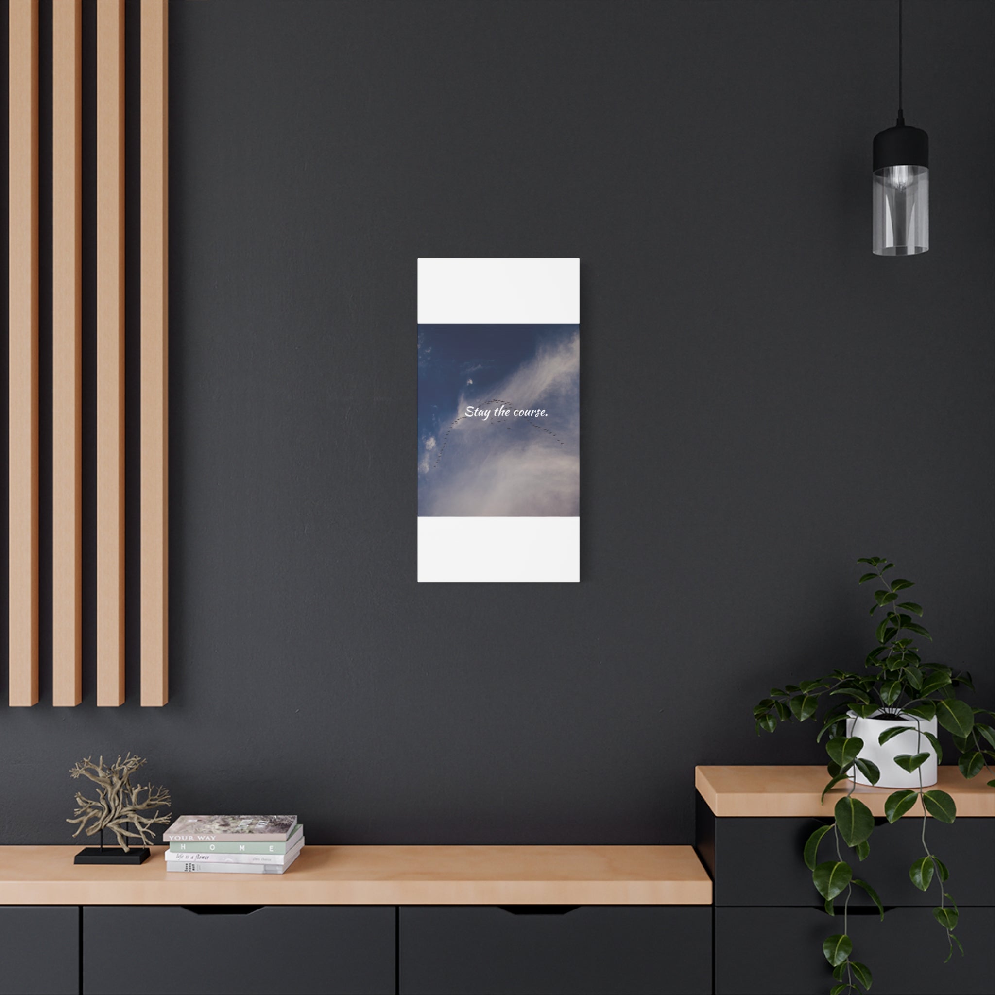 Canvas print of a night sky with clouds on a dark wall in a modern interior.