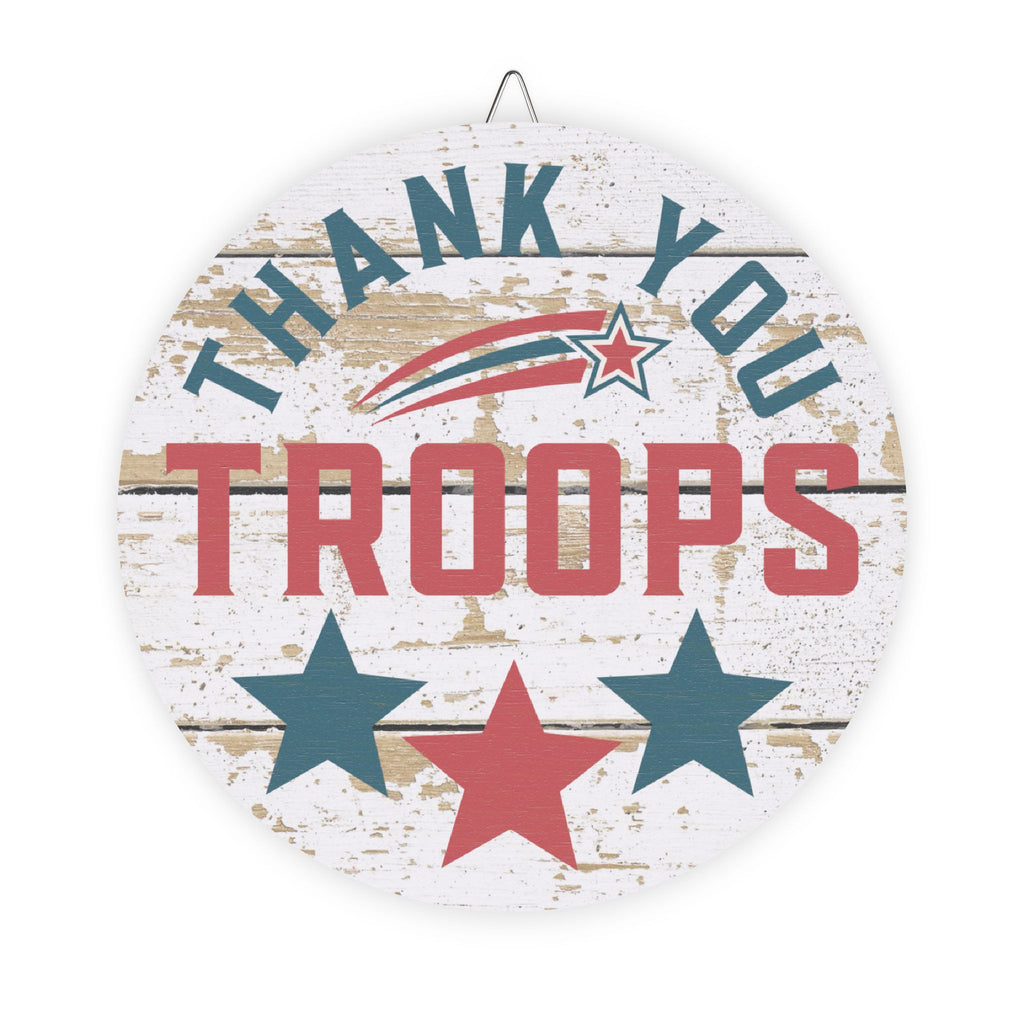 Decorative sign with 'Thank You Troops' text and stars on a wooden planks background