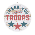 Decorative sign with 'Thank You Troops' text and stars on a wooden planks background