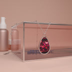 Necklace with a heart-shaped pendant in a clear box on a pink background