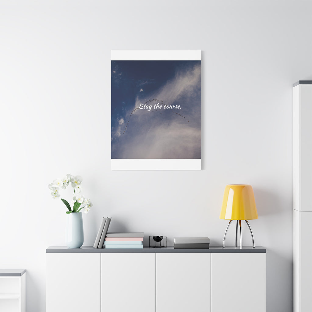Framed artwork with motivational quote on a wall above a white cabinet with decorative items.