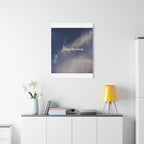 Framed artwork with motivational quote on a wall above a white cabinet with decorative items.