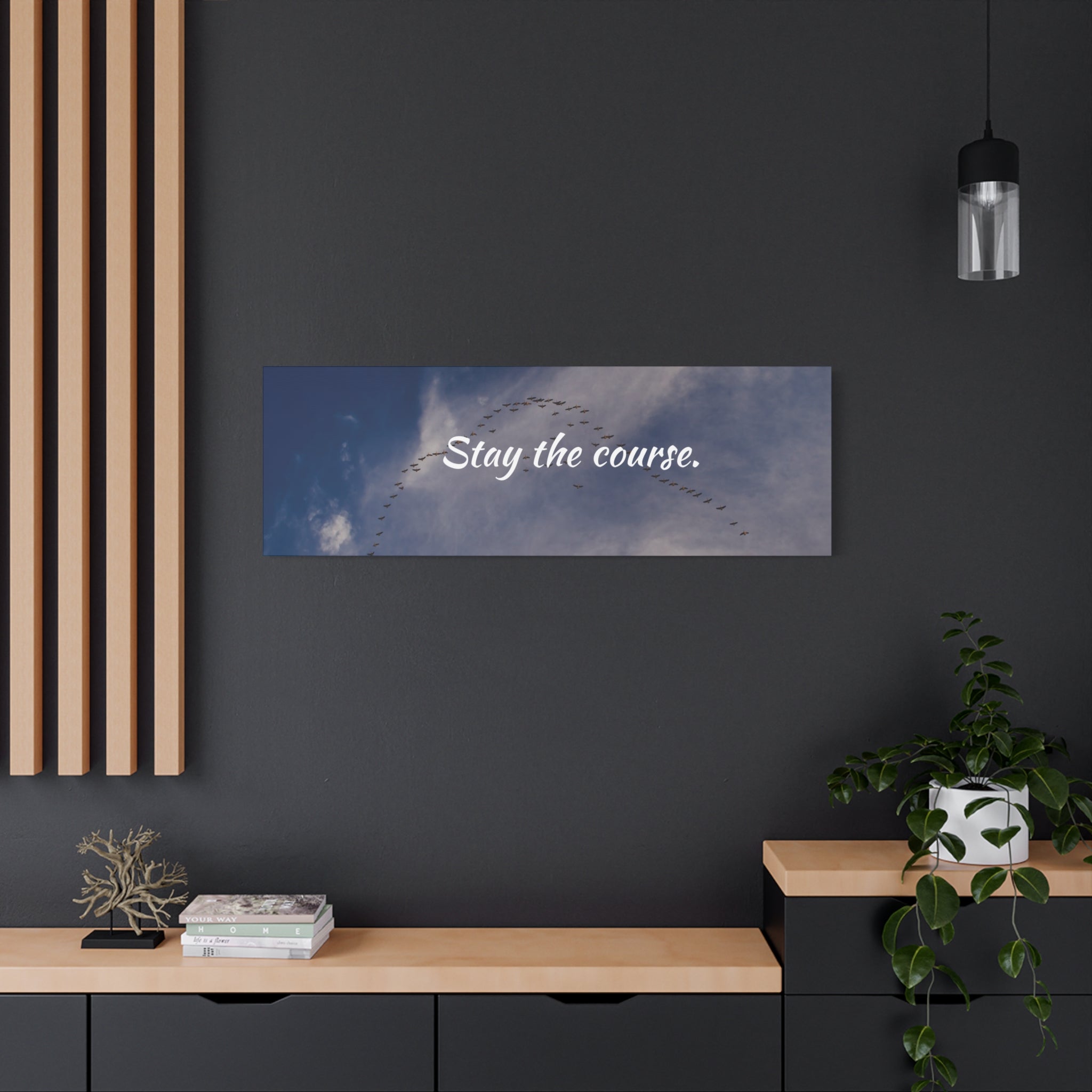Wall art with 'Stay the course.' text in a modern interior setting.