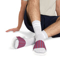 Person wearing white socks with red and blue patterned toes and heels on a white background