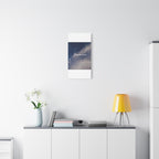 Modern interior with a yellow lamp, vase with flowers, and framed picture on a white wall.