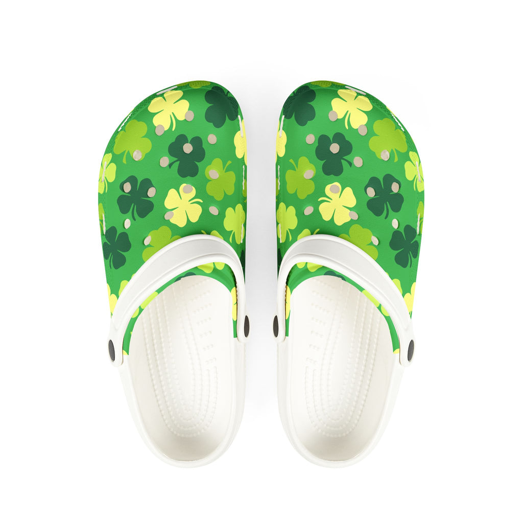 Green floral-patterned clogs with white soles on a white background