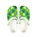 Green floral-patterned clogs with white soles on a white background
