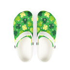 Green floral-patterned clogs with white soles on a white background