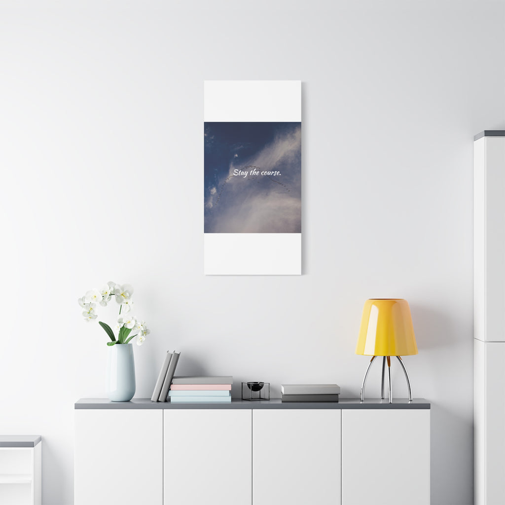 Poster with a cosmic design and text on a white wall above a shelf with decor items.