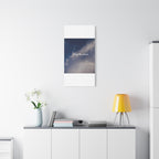 Poster with a cosmic design and text on a white wall above a shelf with decor items.