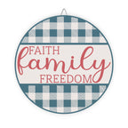 Round sign with 'Faith Family Freedom' text on a blue and white checkered background