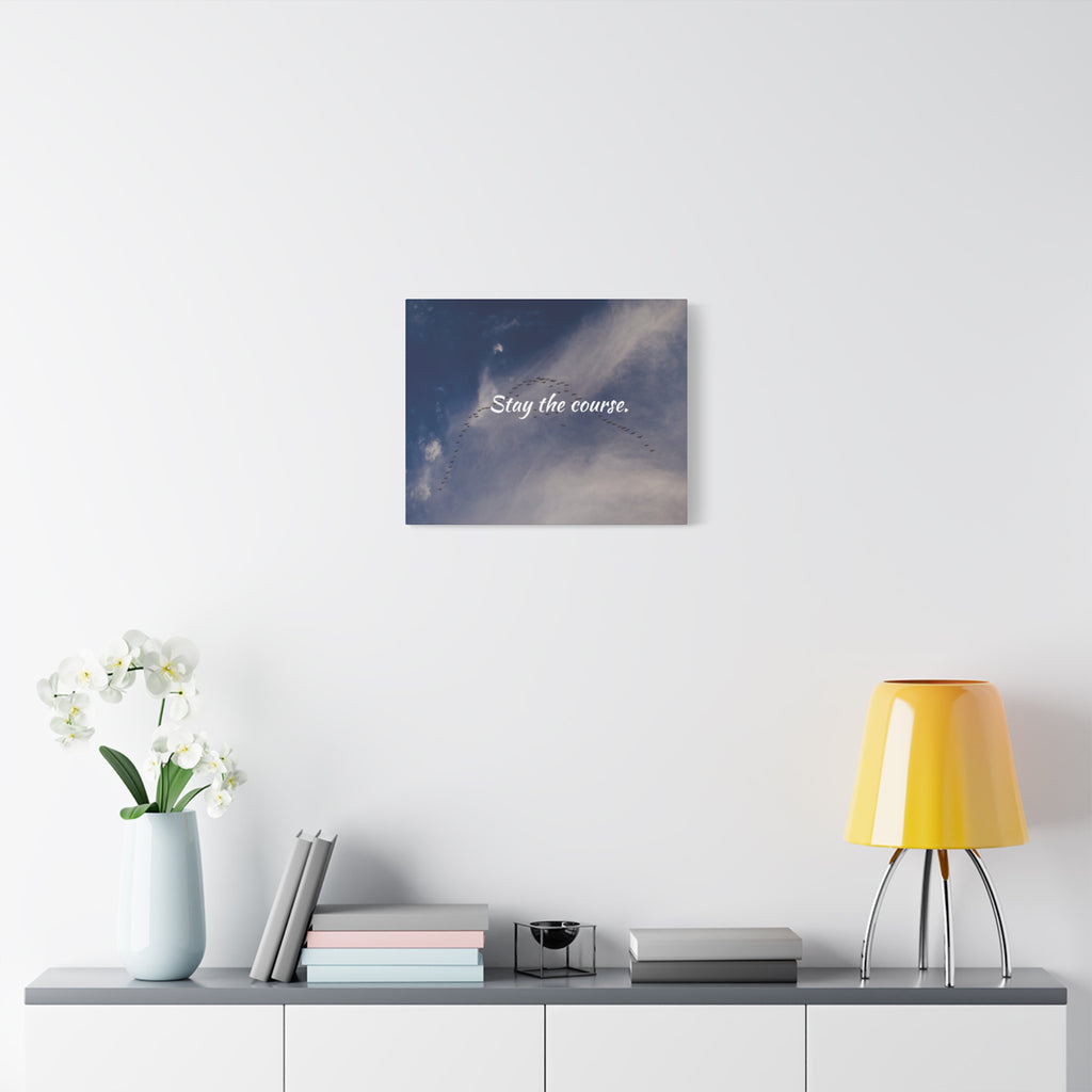 Wall art with motivational quote 'Stay the course' in a modern interior setting.
