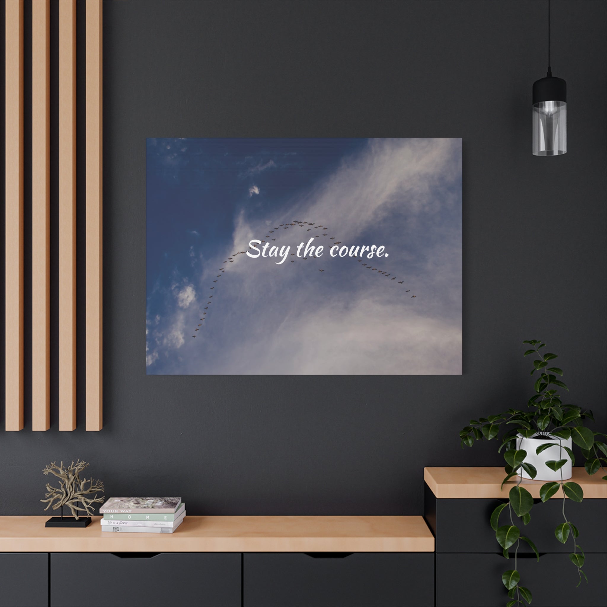 Poster with 'Stay the course.' text on a wall in a modern interior setting.