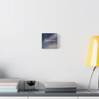 Canvas print with motivational quote on a wall above a desk with books and a lamp.