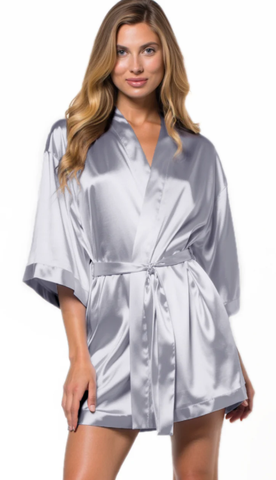 Woman wearing a silver satin robe on a white background