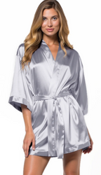 Woman wearing a silver satin robe on a white background