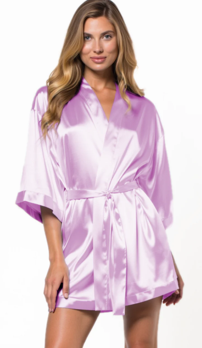 Woman wearing a lavender satin robe on a white background