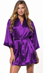 Woman wearing a purple satin robe on a white background