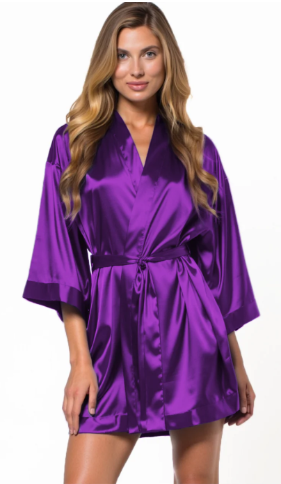 Woman wearing a purple satin robe on a white background