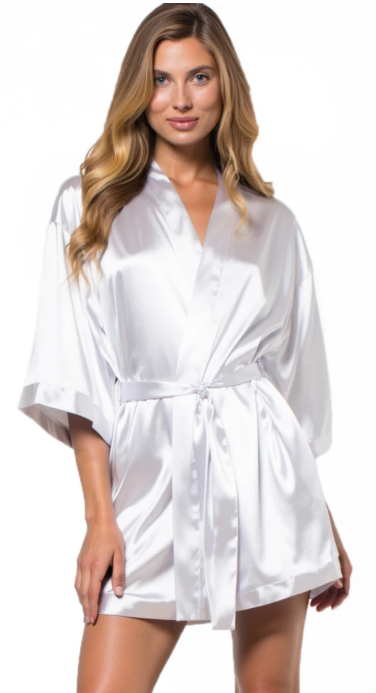 Woman wearing a white satin robe on a white background
