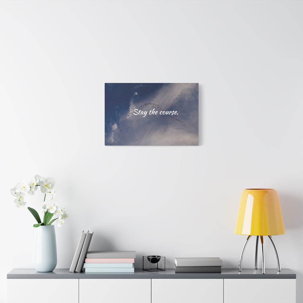Wall art with motivational quote 'Stay the course' on a modern interior setting.